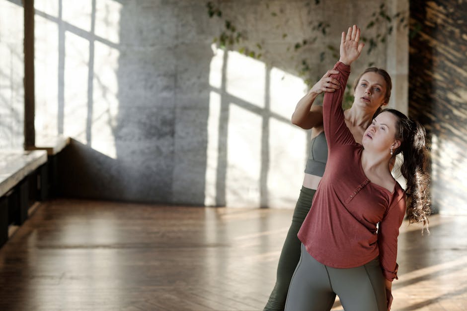 Woman practicing a gentle yoga pose in a sunlit room.